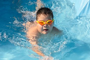 childhood joy during a sunny pool day, complete with...