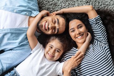 Closeup portrait of happy middle-eastern family cuddling...