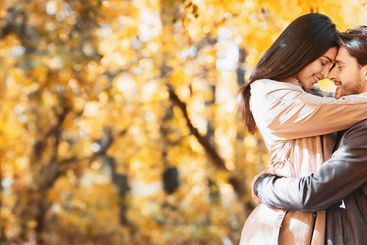 Romantic loving couple cuddling while dating at forest