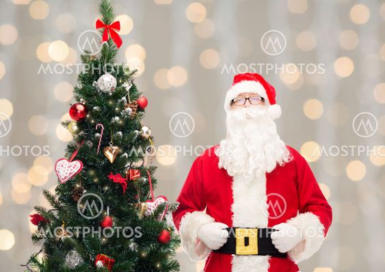 man in costume of santa claus with christmas tree