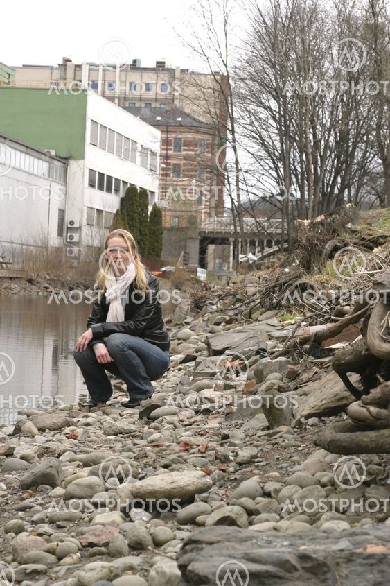 Woman by City River