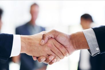 Closeup, business people and handshake in office,...