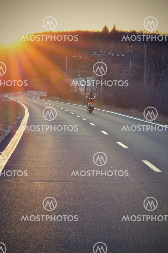 Sunset Highway with scooter / motorcycle
