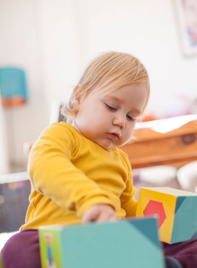 baby playing color boxes
