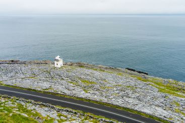 Black Head Lighthouse, situated in the rough rocky...
