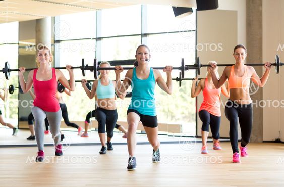 group of women with barbells in gym