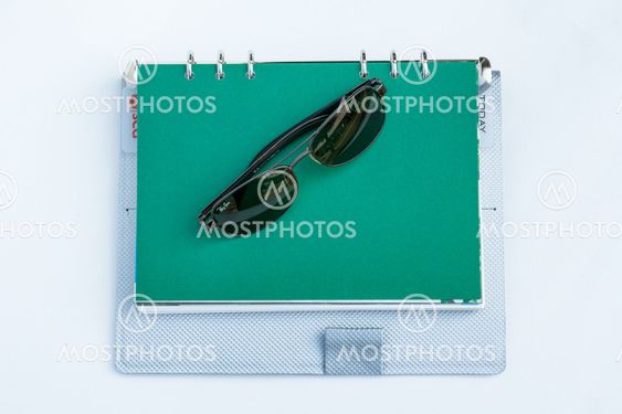 Sunglasses on a spiral notebook