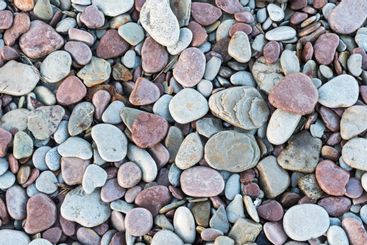 Närbild av småstenar vid stranden, bakgrundsbild