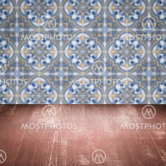 Wood table top and blur vintage ceramic tile pattern wall