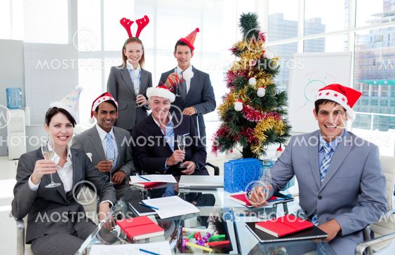 Portrait of a happy business team toasting with Champagne at a Christmas party