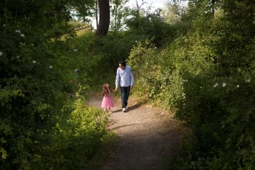 Man walking with his daughter in park