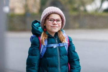 Cute little girl o the way to school. Healthy happy...