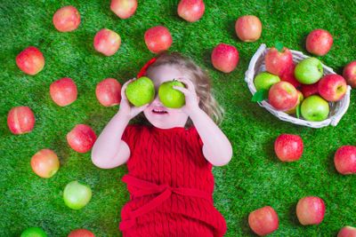 Little girl eating apples