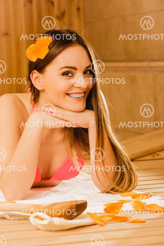 Young woman relaxing in sauna. Spa wellbeing.