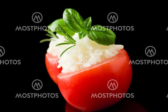 Stuffed tomatoes with rice isolated on black