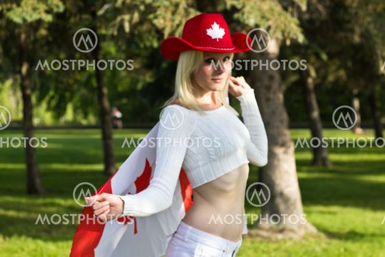 Sexy young Canadian woman with red cowboy hat and Canada flag