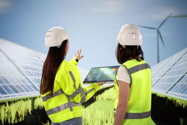 Female photovoltaic energy engineer inspecting solar panels