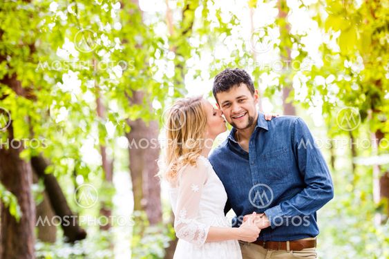 Beautiful wedding couple outside in green forest.