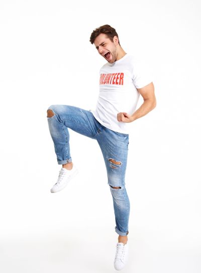 Full length portrait of a happy man in volunteer t-shirt