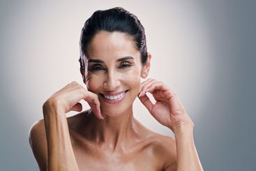 Portrait, happy and mature woman with skincare, studio...