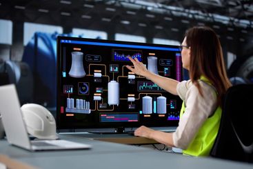 Young female engineer operates SCADA system