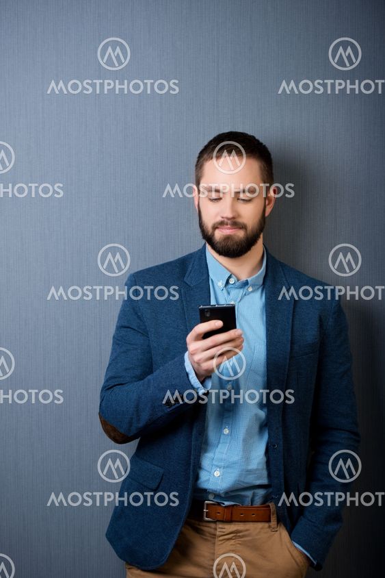 Businessman Text Messaging On Mobile Phone