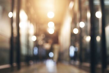 Professional, blurry and walking in lobby to meeting for...