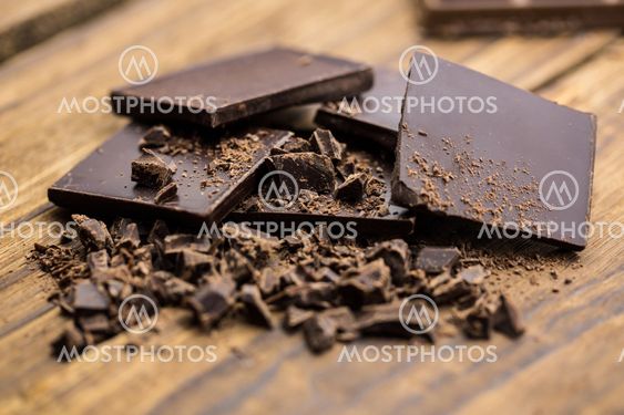 Pieces of chocolate on a wooden table