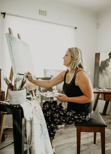 Art, creativity and painting, happy woman in studio at...