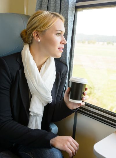 Woman looking out the train window pensive