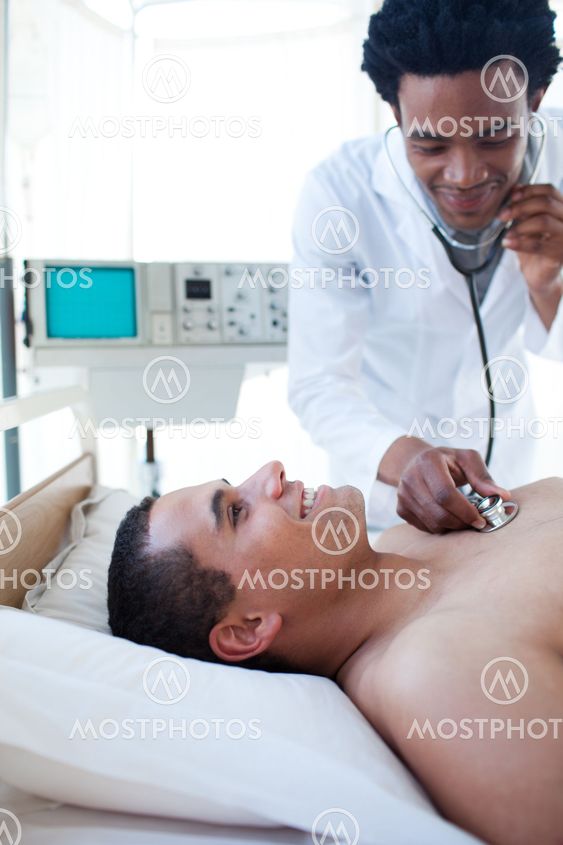 A doctor checking the pulse on a male patient