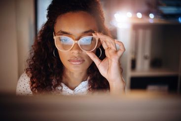 Reading, remote work and woman at night on laptop for...