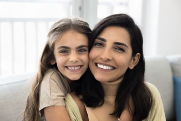 Close up shot beautiful woman posing with her little...