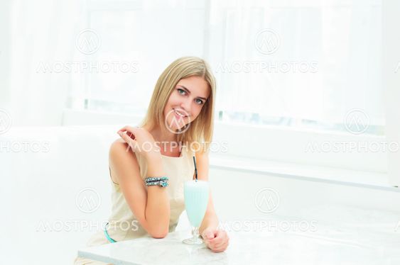 Portrait of a cute woman in a city cafe