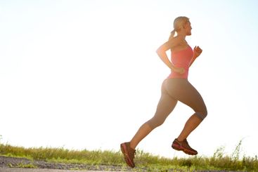 Woman, profile and running with blue sky on asphalt for...