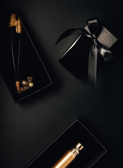 top view of bottled perfumes and decorative feathers on...