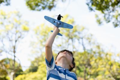 Boy playing with a toy aeroplane