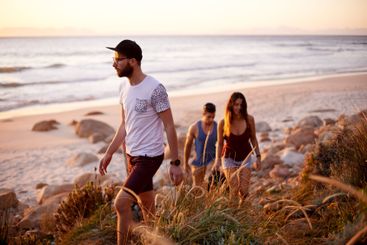 Friends, travel and walk at ocean for journey, summer...