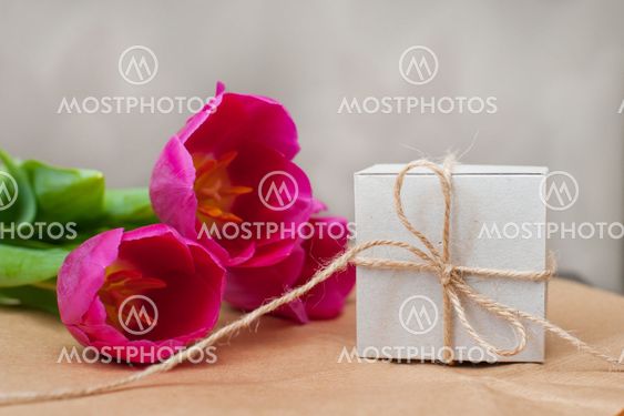 three purple tulip and a box for gift