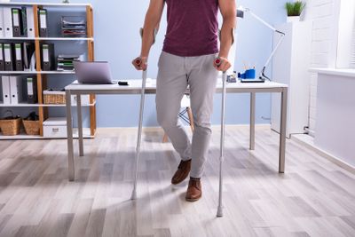 Handicapped Man Walking With Crutches