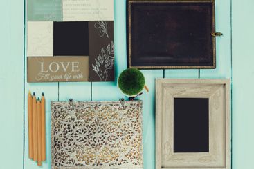 Craft supplies and decorative frames arranged on a light...