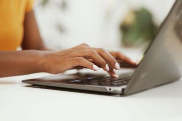 Remote work, typing and laptop with hands of person in...