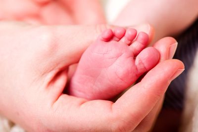 Hand Holding Baby Feet
