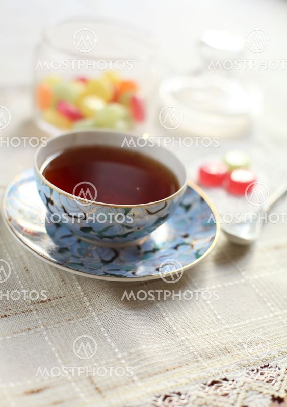 Tea with coloured sugar candies in a glass can