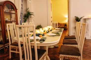 A dining table covered with candles and Christmas decor....