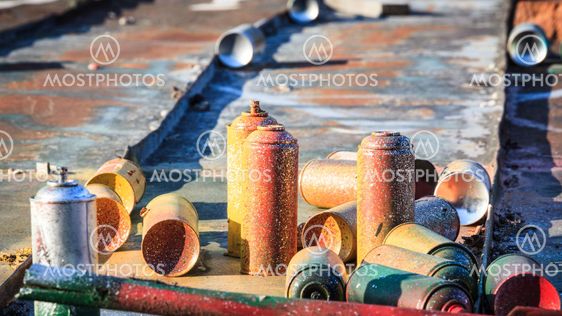 Used graffiti spray cans laying around
