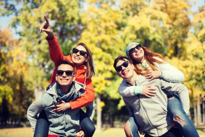 happy friends in shades having fun at autumn park