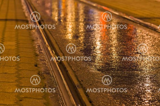 Closeup on tram rail by night