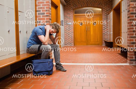 Sad student sitting on a bench