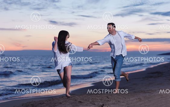 happy young romantic couple in love have fun on beautiful beach at beautiful summer day